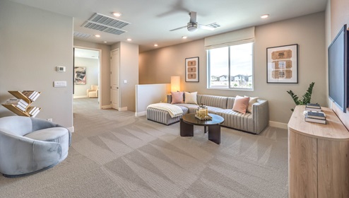 The upstairs loft in our 3001 model with carpet flooring and large windows.