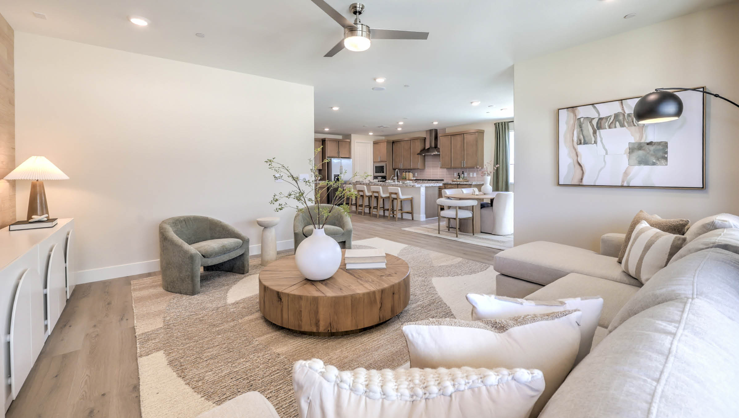 The Heartland Summit 4425 Plan open concept Great Room with Luxury Vinyl Plank Flooring and large windows.