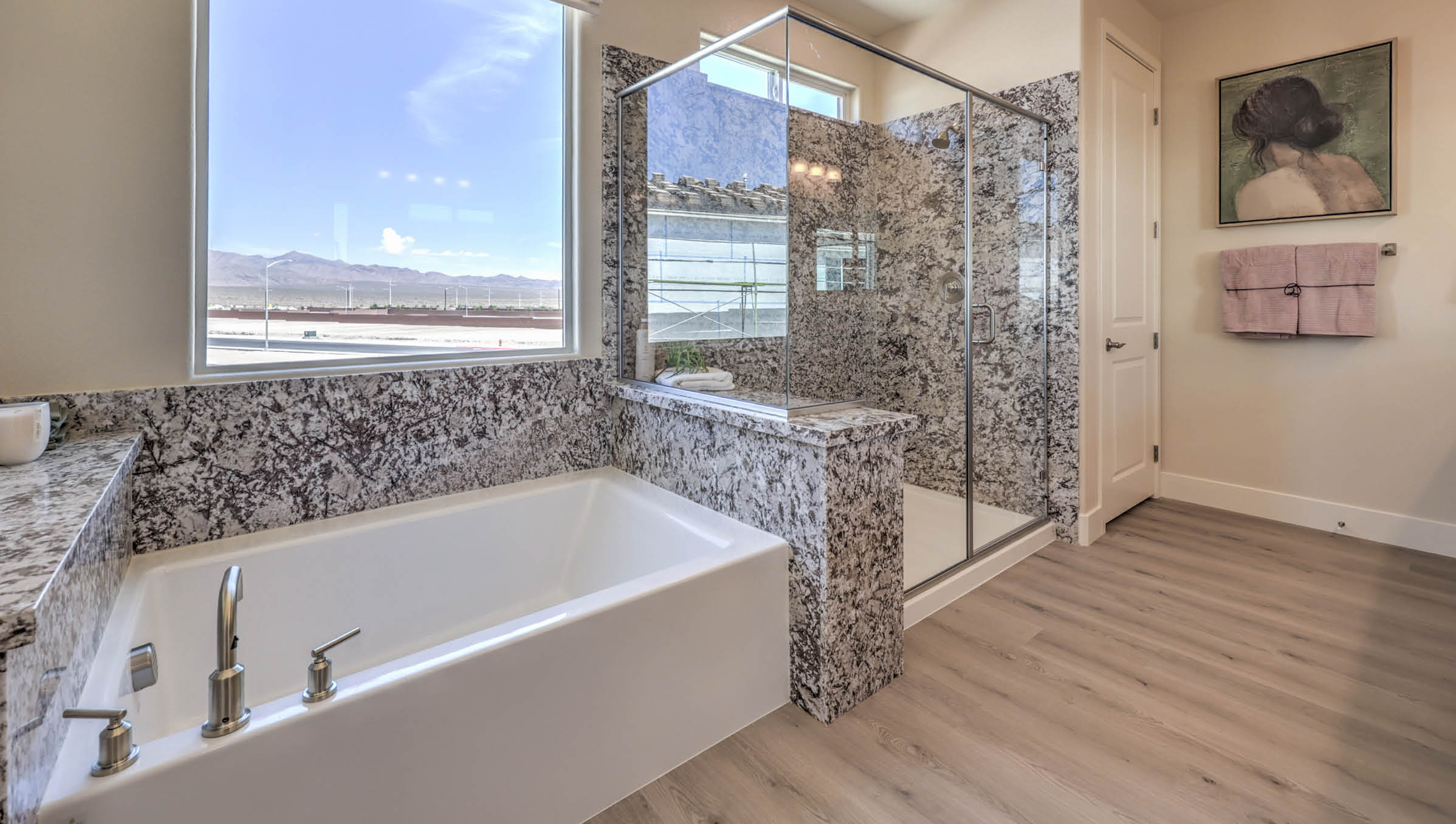 Attached to the Bedroom One Suite, our 4425 model bathroom with granite countertops at the double Bath Vanity, a walk-in closet, mirror, and brown cabinets.