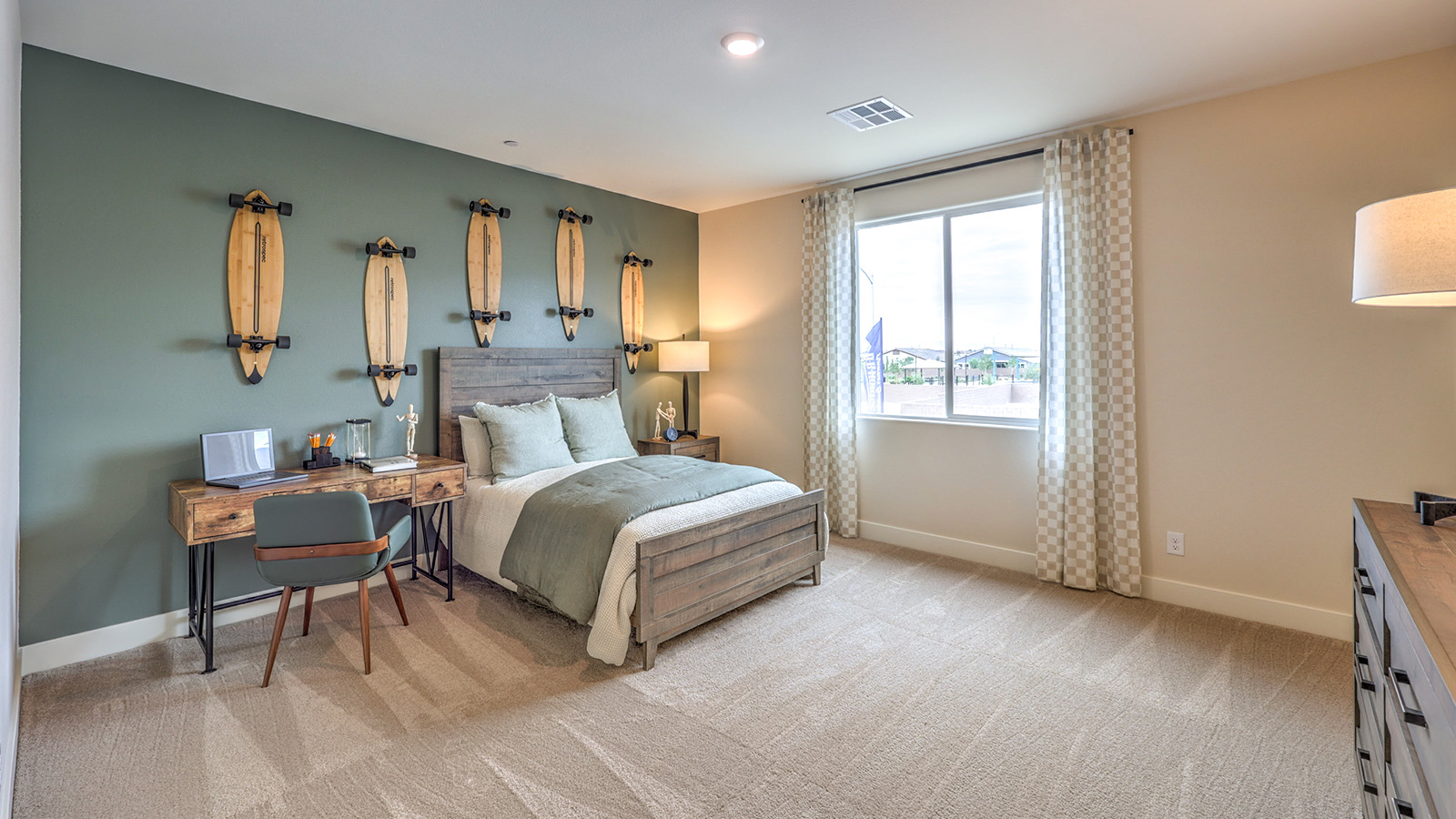 Bedroom Three in our Heartland Summit 4425 model with carpet flooring, a walk-in closet, and a window.