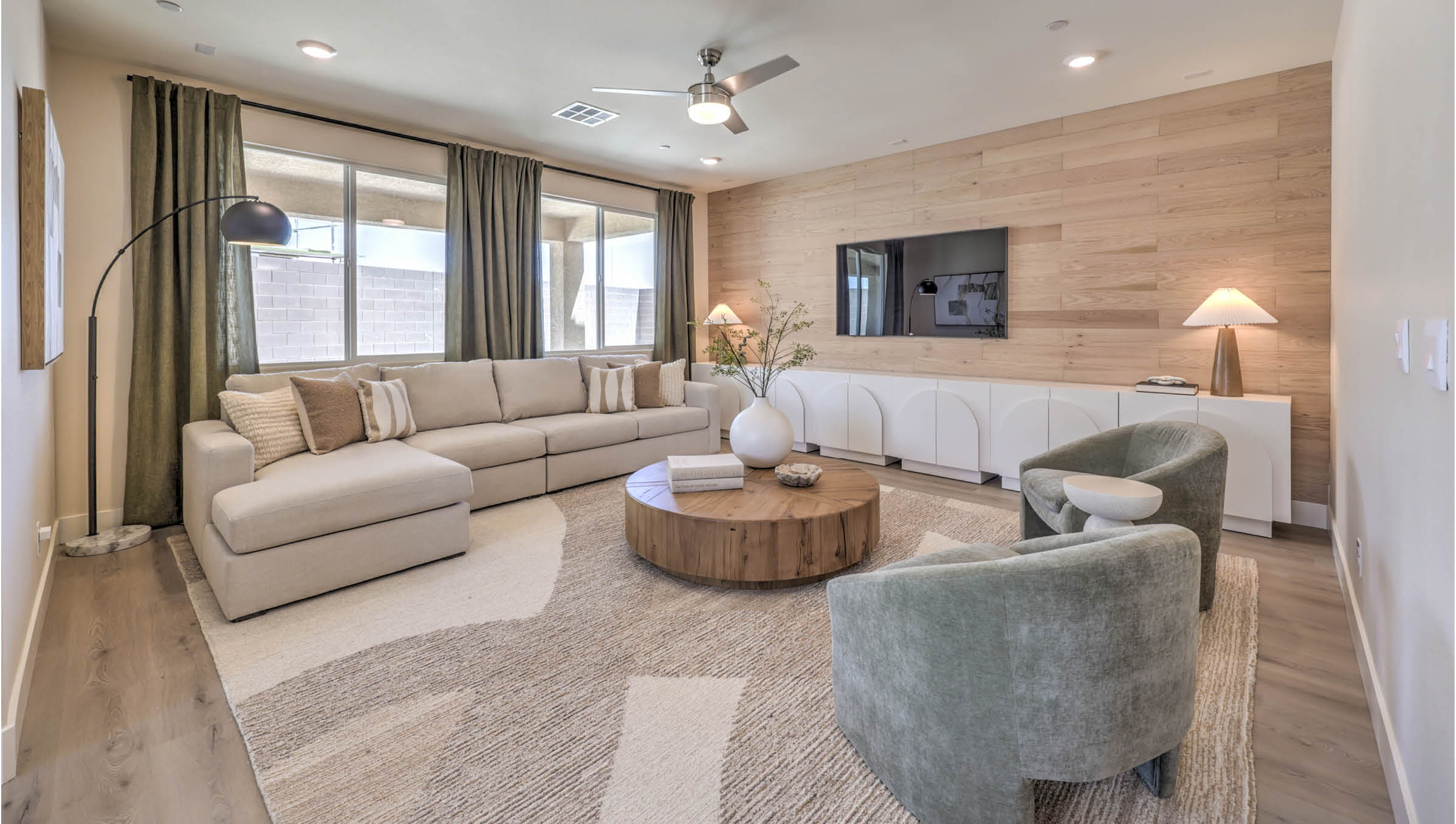 The Heartland Summit 4425 Plan open concept Great Room with Luxury Vinyl Plank Flooring and large windows.