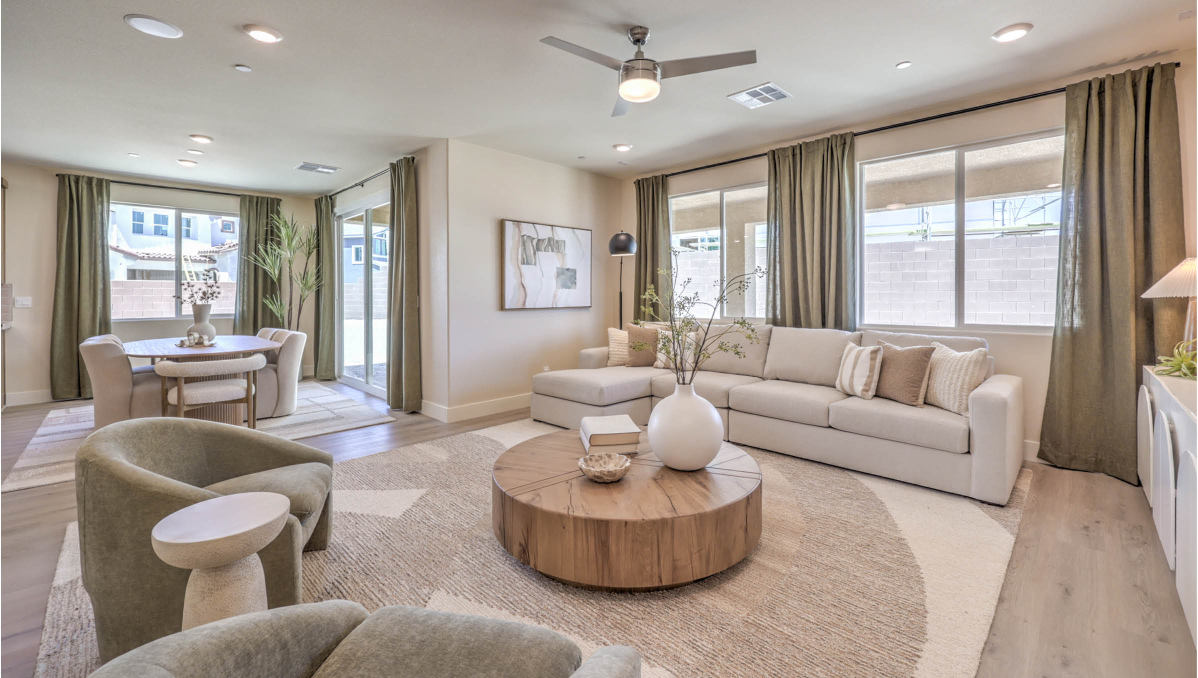 The Heartland Summit 4425 Plan open concept Great Room with Luxury Vinyl Plank Flooring and large windows.