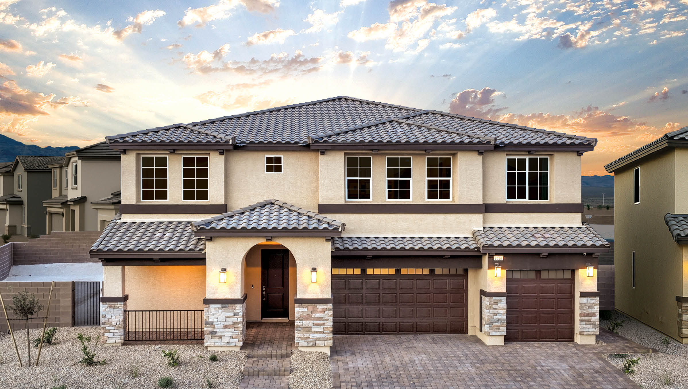 Exteriors in our Symmetry Summit Community Featuring designer-selected paint schemes, front yard landscaping, paver walkways, and 3-car garages.