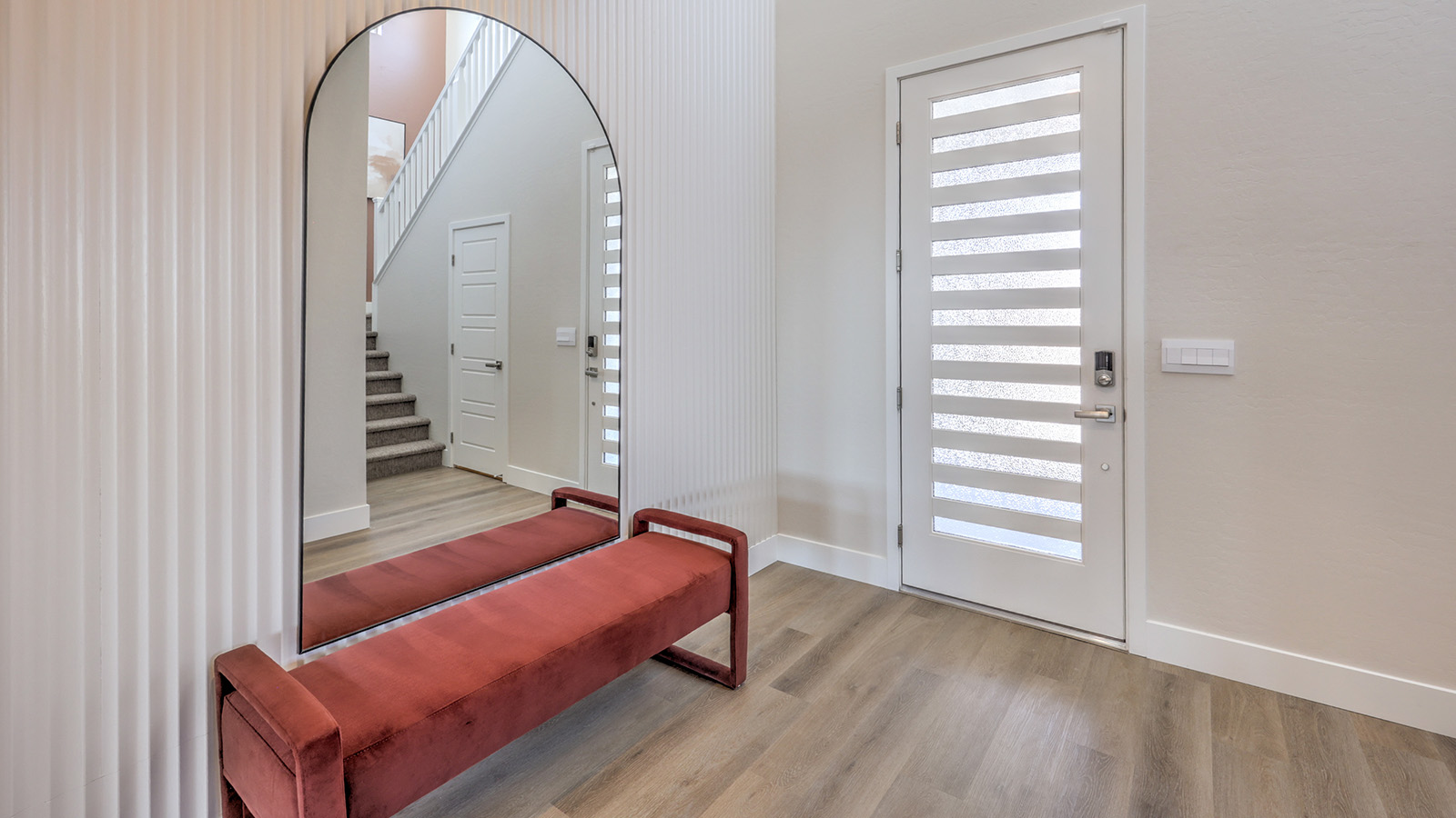 The front door entrance to our Heartland Summit 4418 model with Luxury Vinyl Plank Flooring