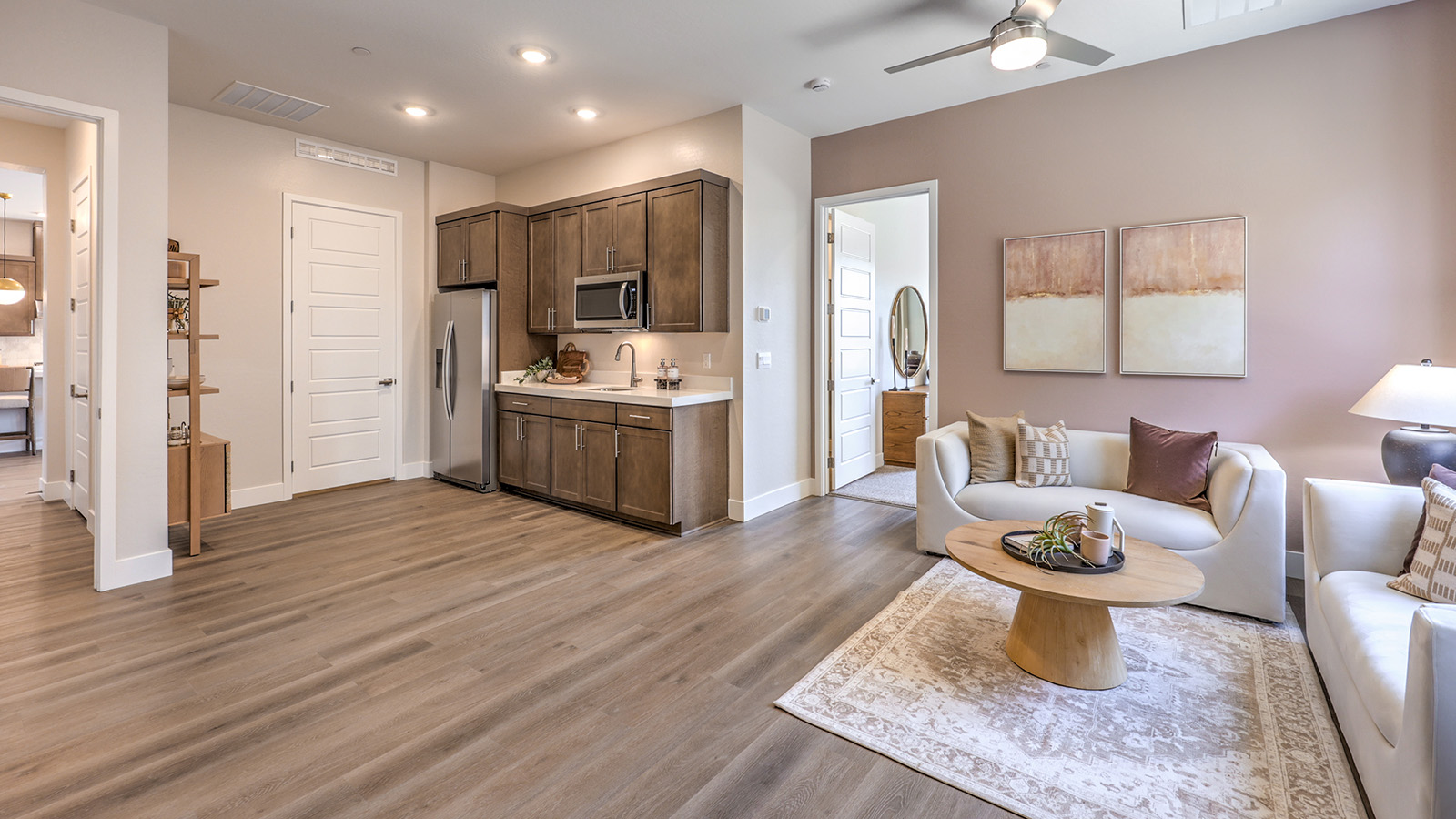 Our Heartland Summit 4418 Multigen with a Whirlpool stainless steel refrigerator, sink, shaker style cabinets, and quartz countertops.