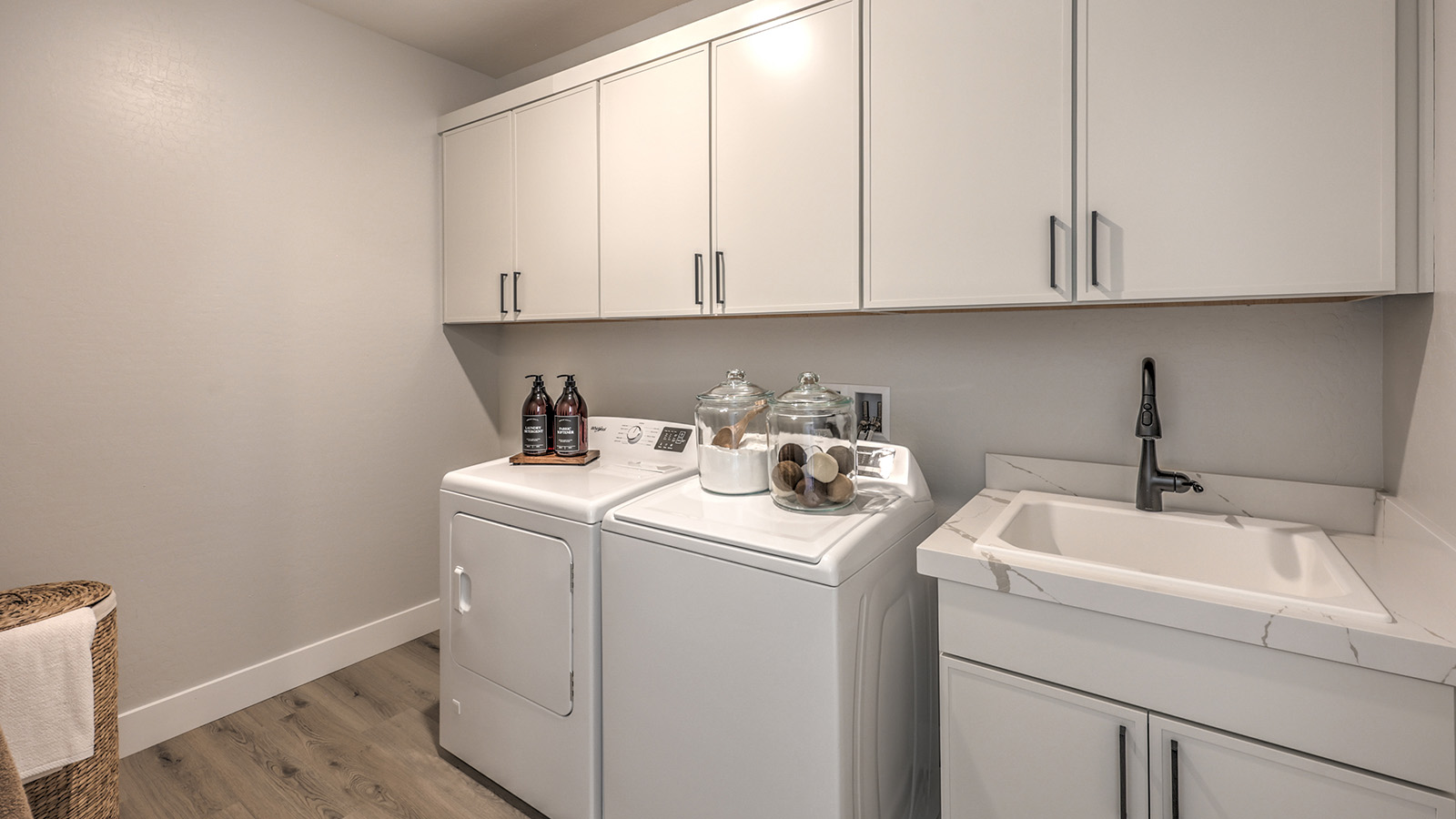 Our Heartland Summit 3774 model laundry room with cabinets and a washer and dryer.