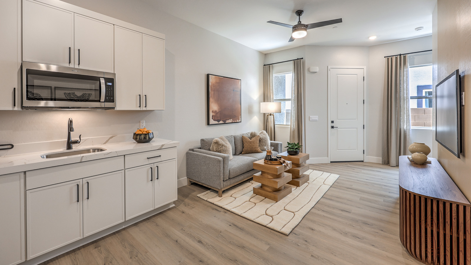 Our Heartland Summit 3774 Multigen with a Whirlpool stainless steel refrigerator, sink, shaker style cabinets, and granite countertops.