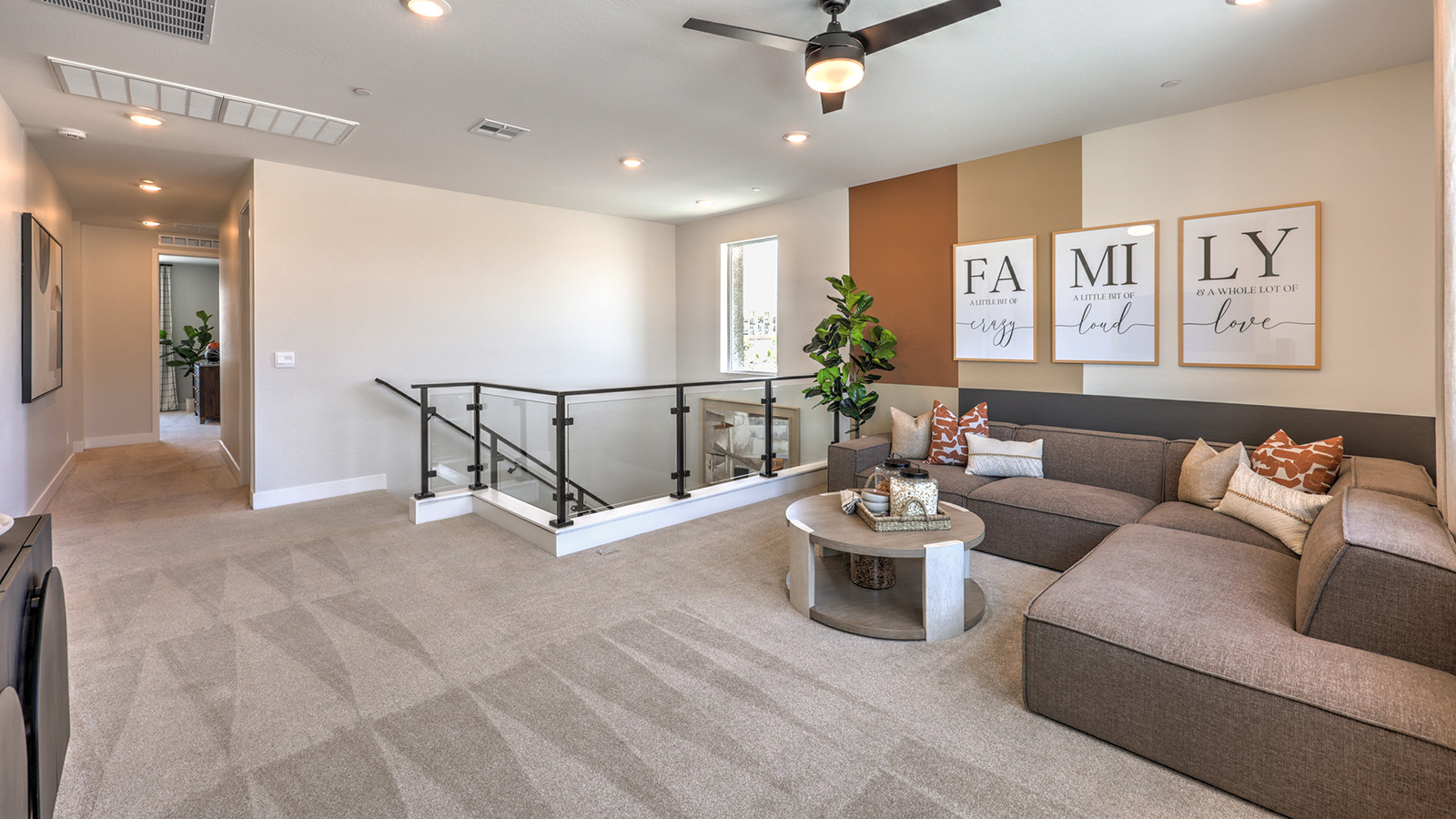 The upstairs loft in our 3774 model with carpet flooring and large windows.