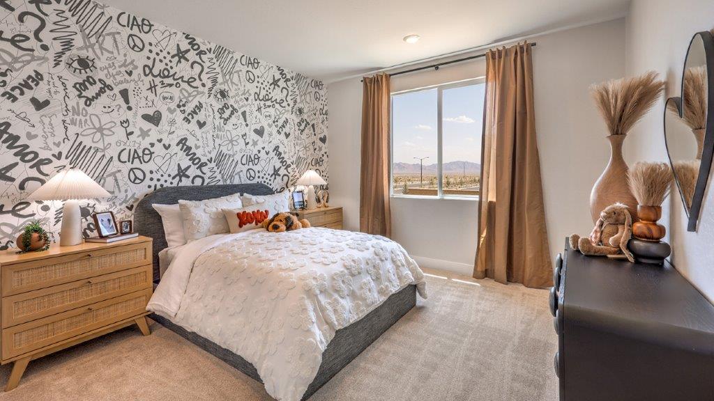 Bedroom Two in our Heartland Summit 3774 model with carpet flooring, a sliding closet, and a window.