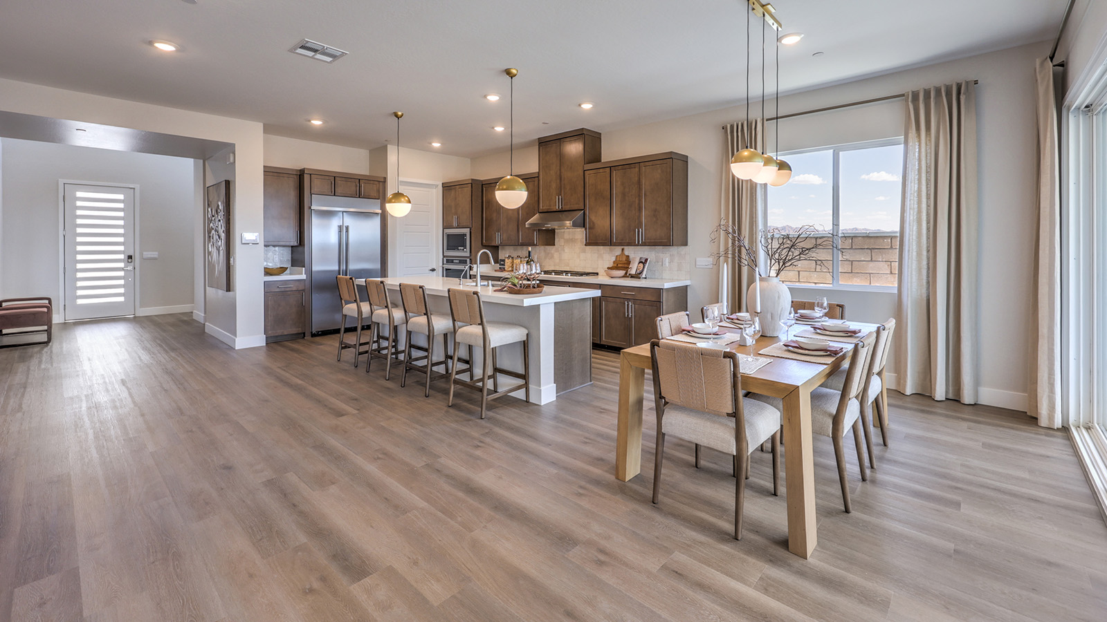 The Heartland Summit 4418 model Dining Room adjacent to the kitchen and great room with a table and large window.