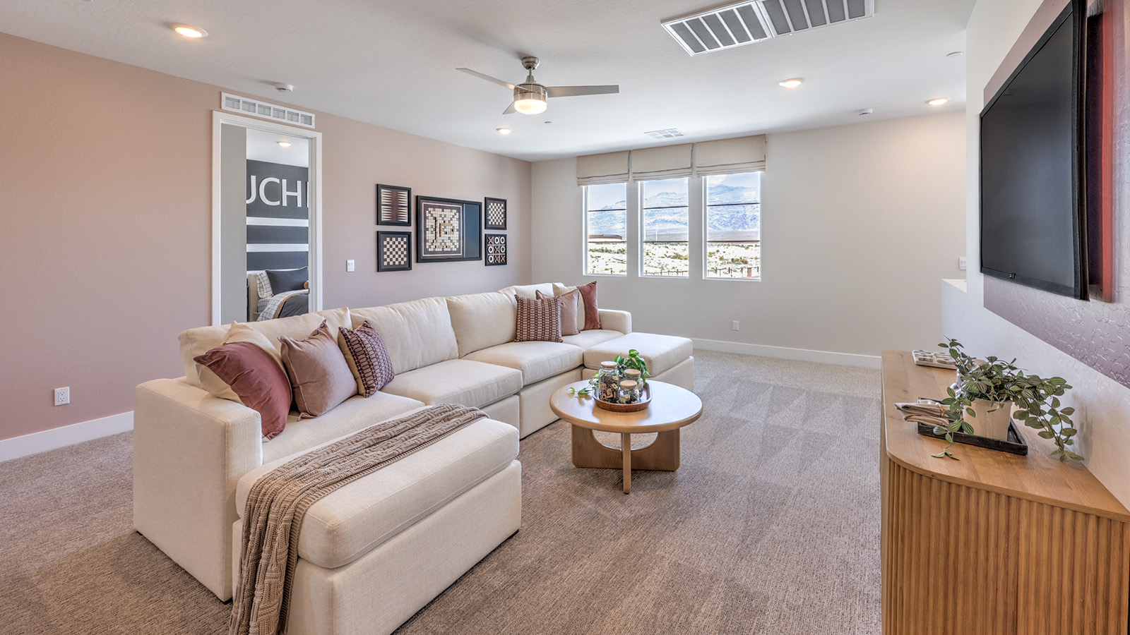The upstairs loft in our 4418 model with carpet flooring and large windows.