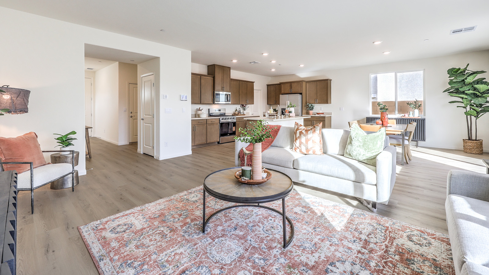 The Tropical Falls 2436 Plan open concept Great Room with ceramic tile flooring, large windows, and a sliding door to the backyard.