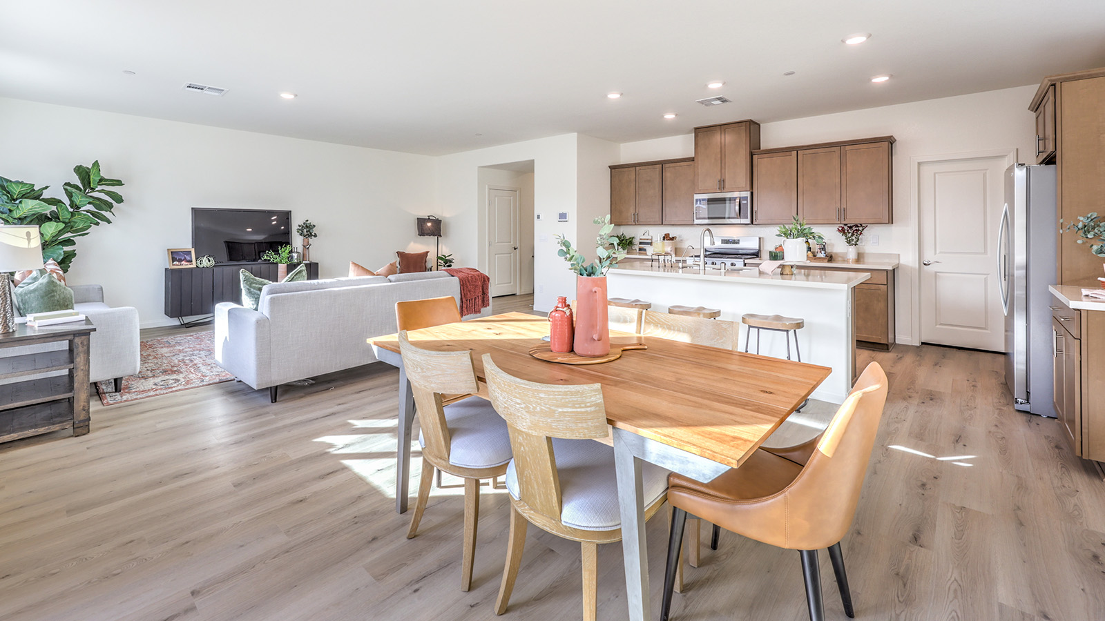 The Tropical Falls 2436 model Dining Room adjacent to the kitchen with a table and window.
