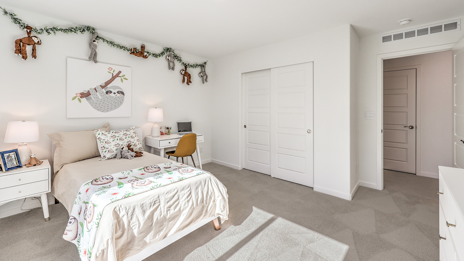 Bedroom Four in our Tropical Falls 2660 model with carpet flooring, a sliding closet, and a window.