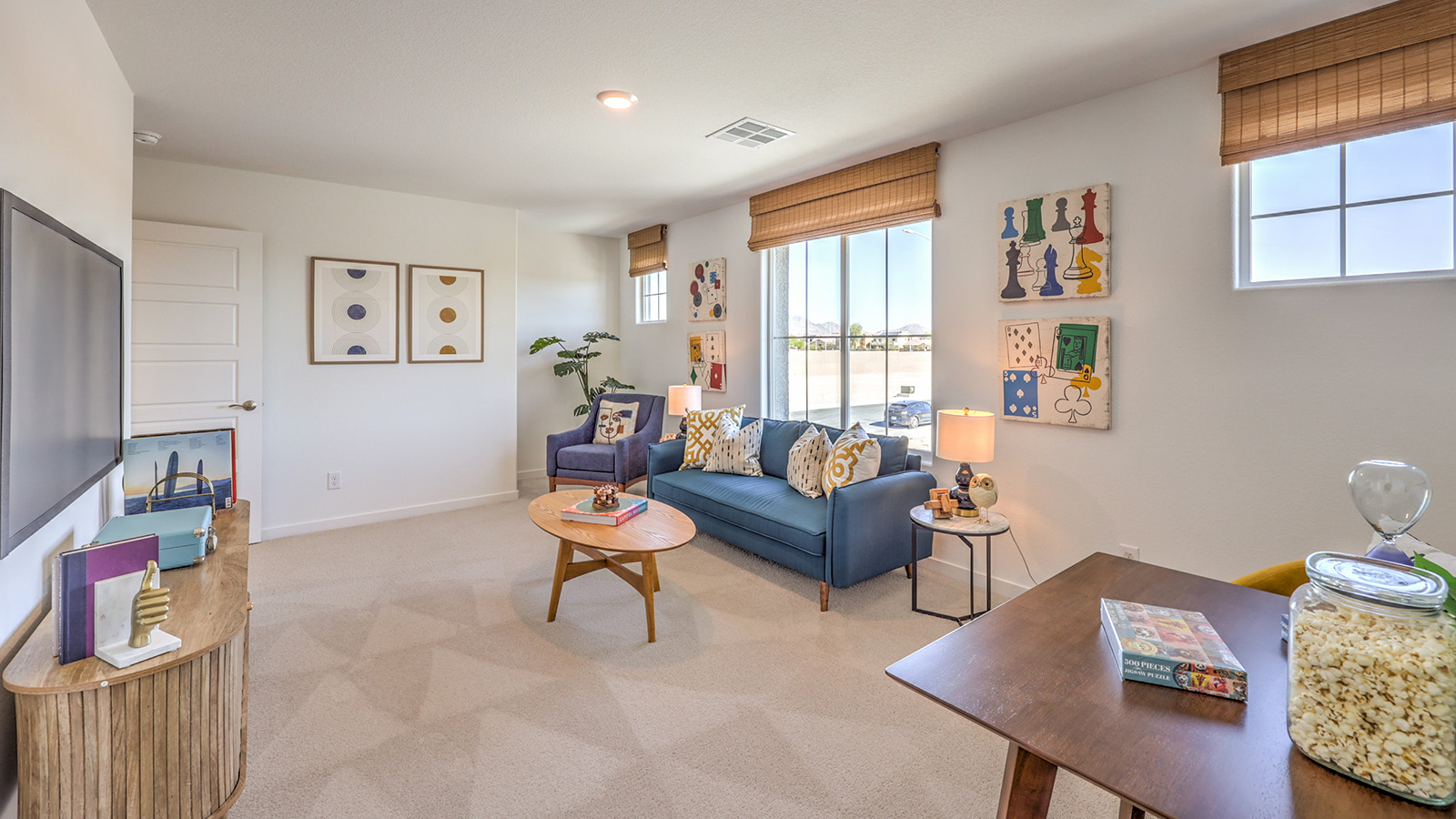 The upstairs loft in our 2600 model with carpet flooring and large windows.