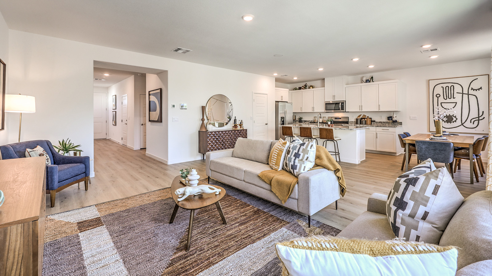 The Tropical Falls 2660 Plan open concept Great Room with luxury vinyl flooring, large windows, and a sliding door to the backyard.