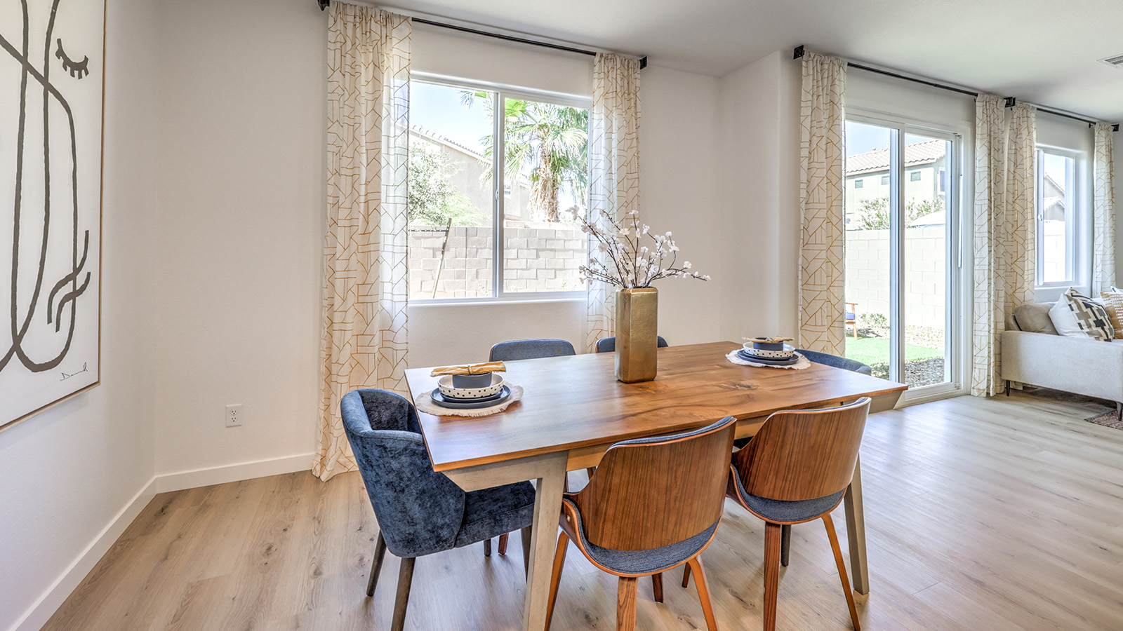 The Tropical Falls 2660 model Dining Room adjacent to the kitchen with a table and window.
