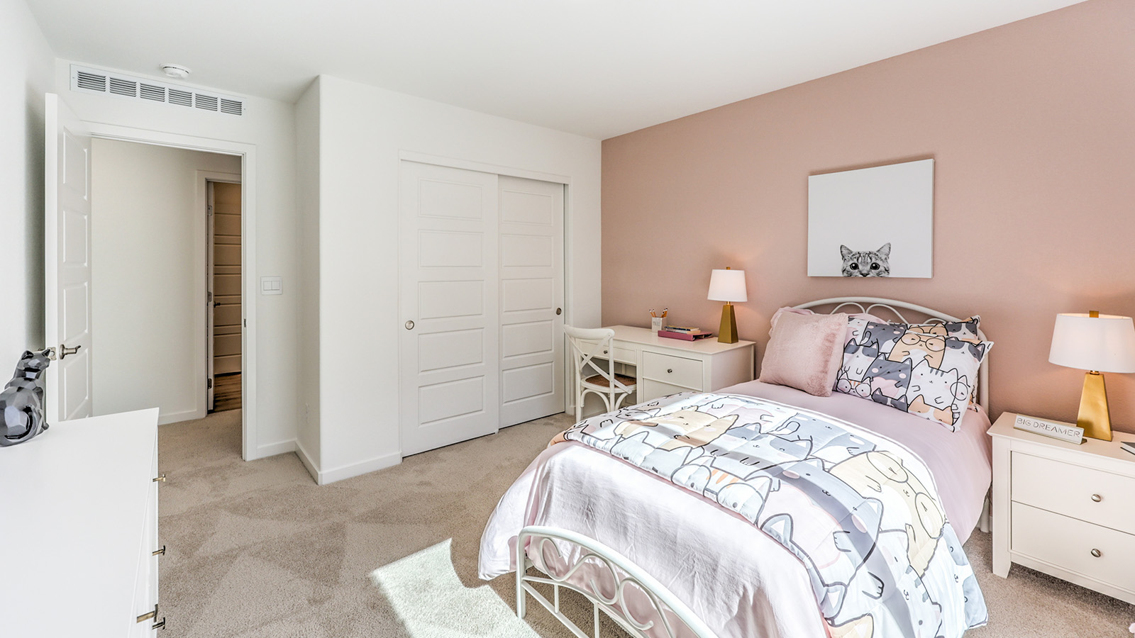 Bedroom Three in our Tropical Falls 2660 model with carpet flooring, a sliding closet, and a window.