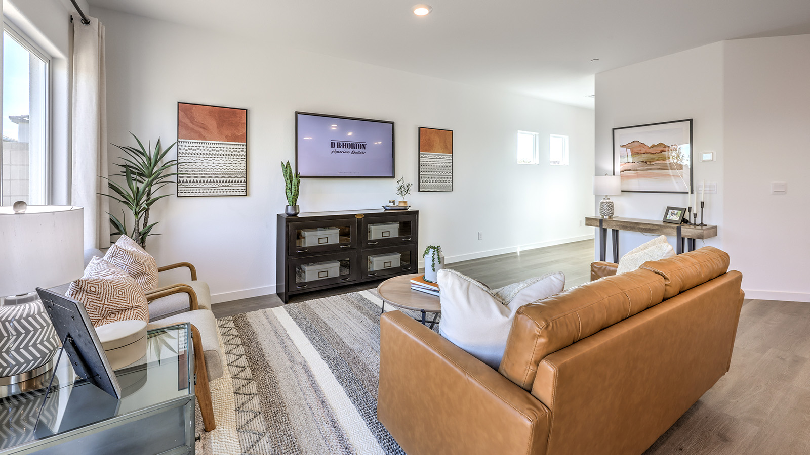 The Meranto Bay 1802 Plan open concept Great Room with LVP panel flooring and a sliding door to the backyard.