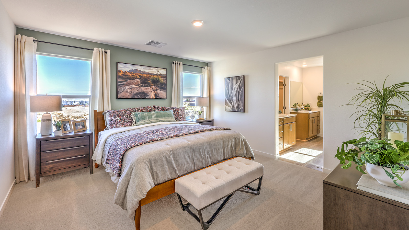 The Bedroom One Suite in our Symmetry Bay 1802 model with carpet flooring and recessed ceiling lights.