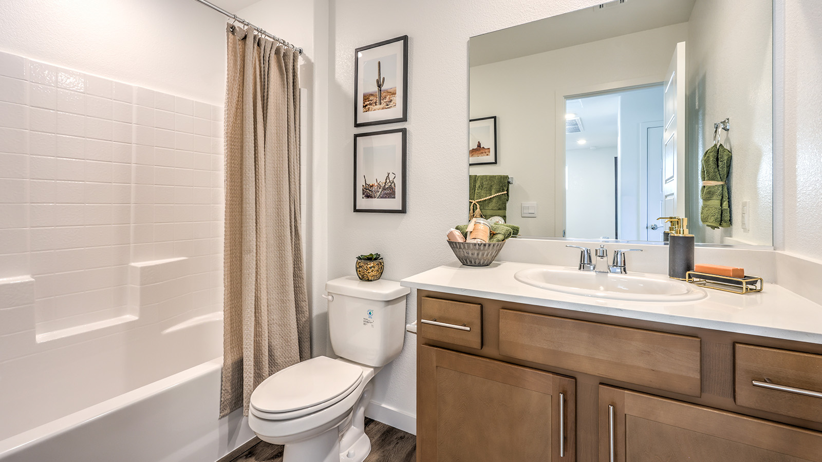 Bathroom Two in our Meranto Bay 1802 model with granite countertops at the Bath Vanity, a walk-in shower, mirror, and brown cabinets.
