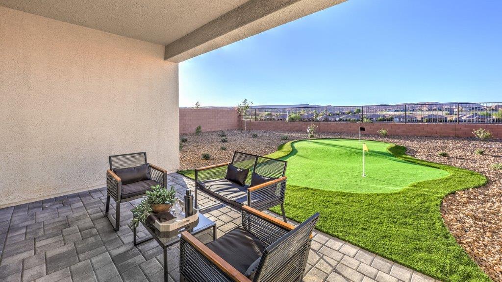 Our Majestic Hills 2390 model backyard with desert landscaping and a seating area.