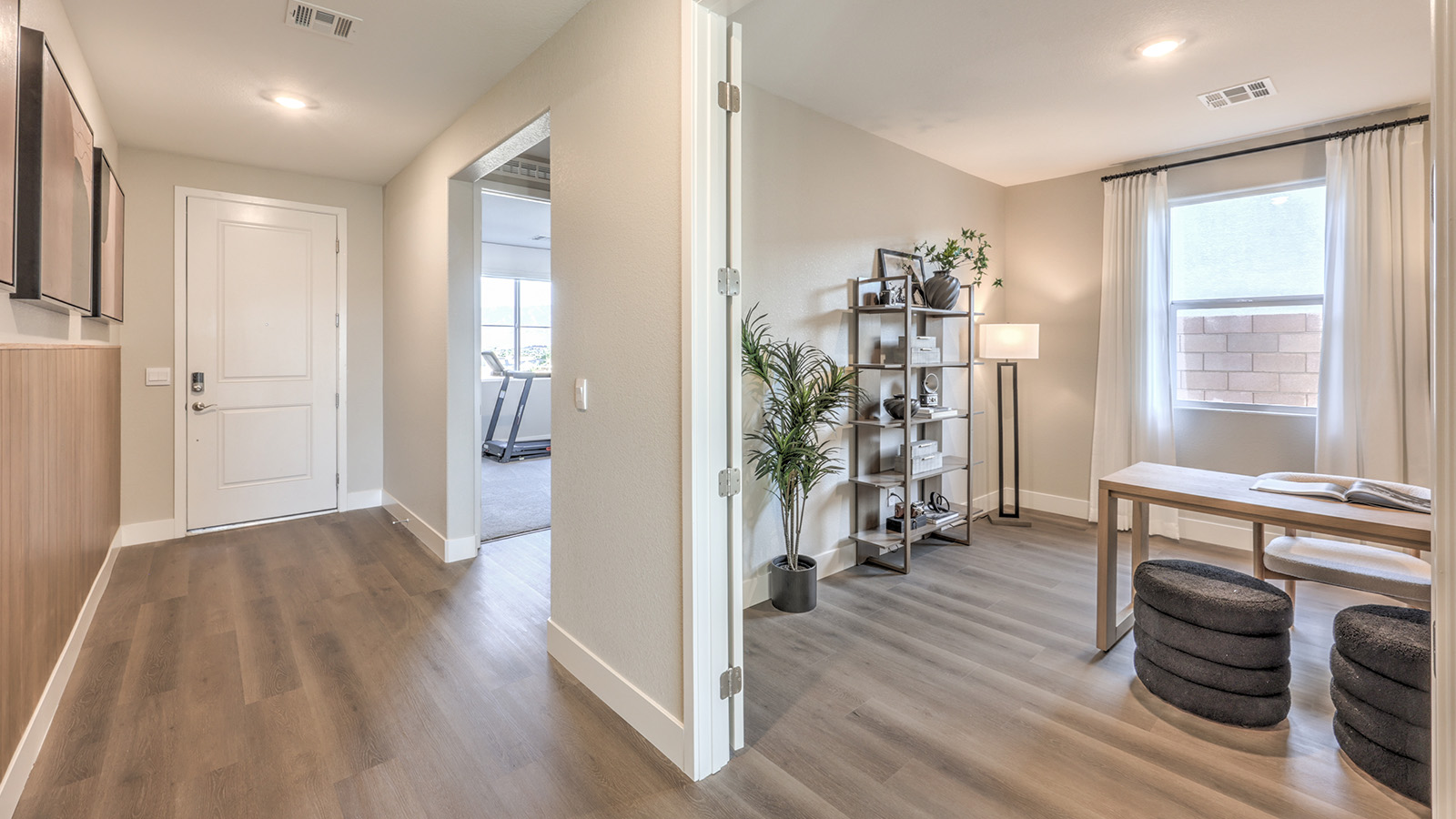 The Majestic Hills 2390 Plan Entrance featuring Luxury Vinyl Plank flooring, a wide front door entryway, and an open view into the adjacent dining area, designed to create a bright and welcoming first impression.