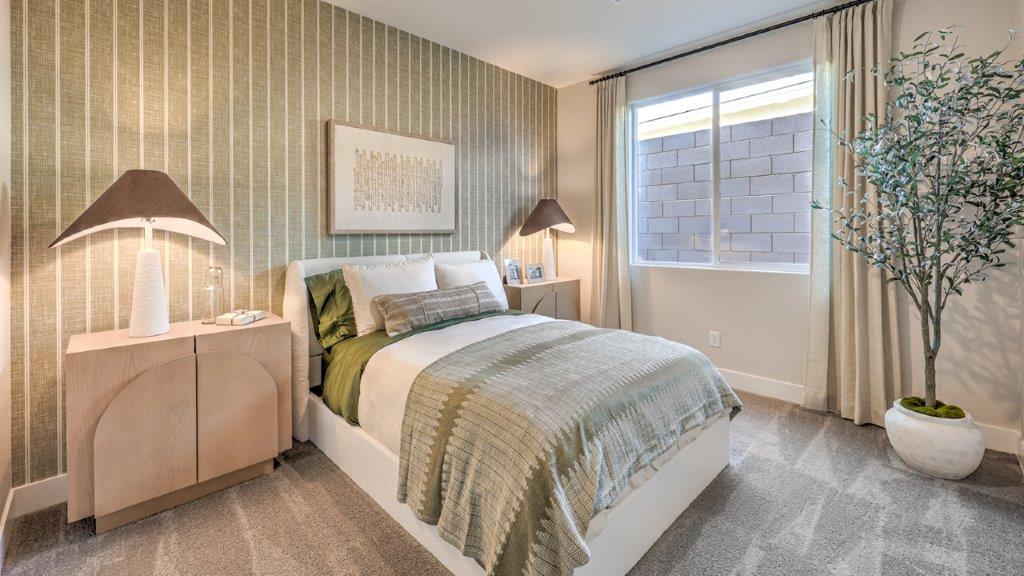 The Majestic Hills 2650 Plan Bedroom 3 featuring plush wall-to-wall carpet, a wide window for natural light, and a double-door closet for convenient storage. This versatile room offers a comfortable layout suitable for a guest room, children’s room, or home office.