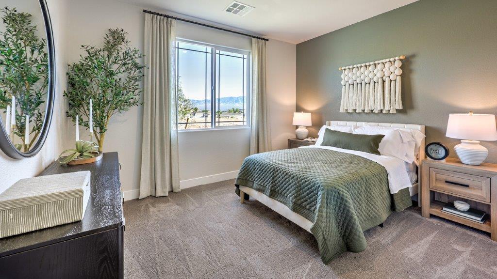 The Majestic Hills 2650 Plan Bedroom 4 featuring plush wall-to-wall carpet, a spacious layout, and a double-door closet for ample storage. Conveniently located near a shared bathroom, this room offers comfort and flexibility for guests, children, or a home office setup.