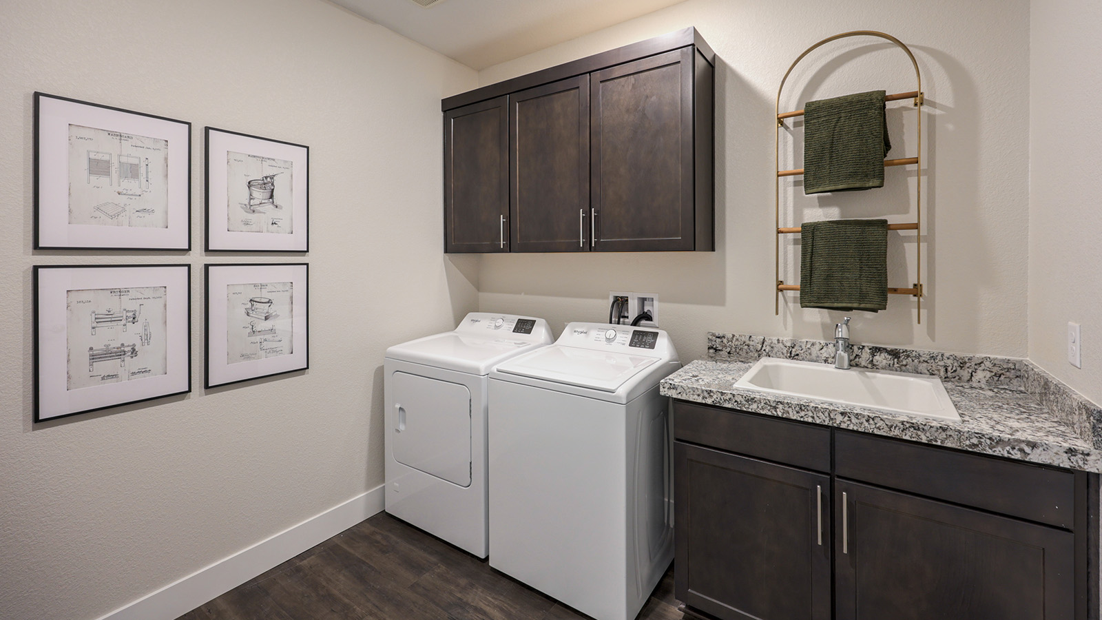 Our Majestic Hills 2650 model laundry room with a shelf and washer and dryer.