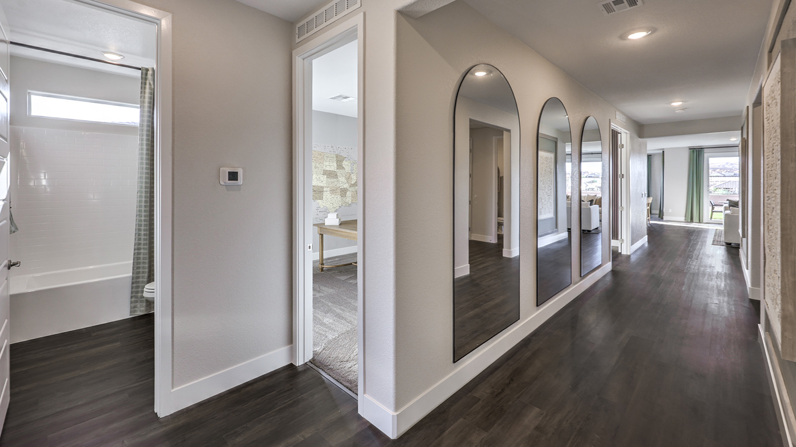 The Majestic Hills 2650 Plan Entrance featuring Luxury Vinyl Plank flooring, a wide front door entryway, and an open view into the adjacent dining area, designed to create a bright and welcoming first impression.