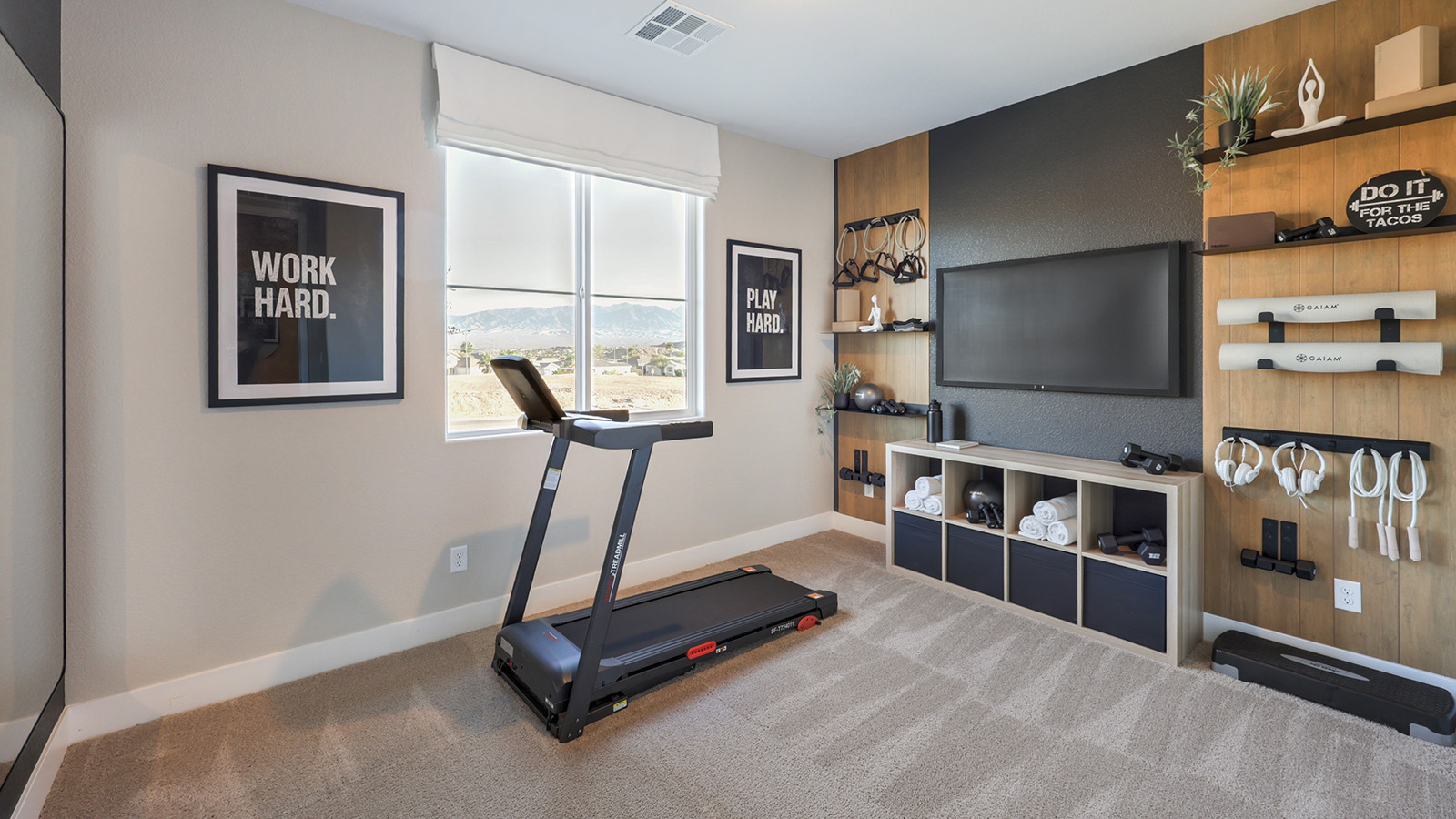 The Majestic Hills 2390 Plan Bedroom 2 featuring plush wall-to-wall carpet, a large window for natural light, and a double-door closet for storage. Conveniently located near shared living spaces, this versatile bedroom is ideal for guests, family members, or a home office.