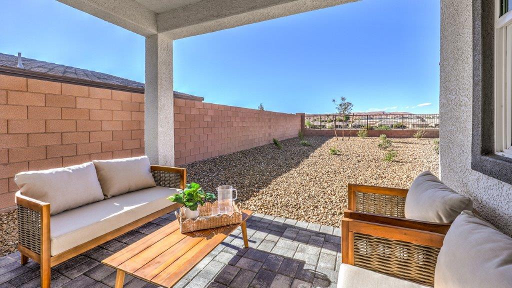 Our Majestic Hills 1617 model backyard with desert landscaping and a seating area.
