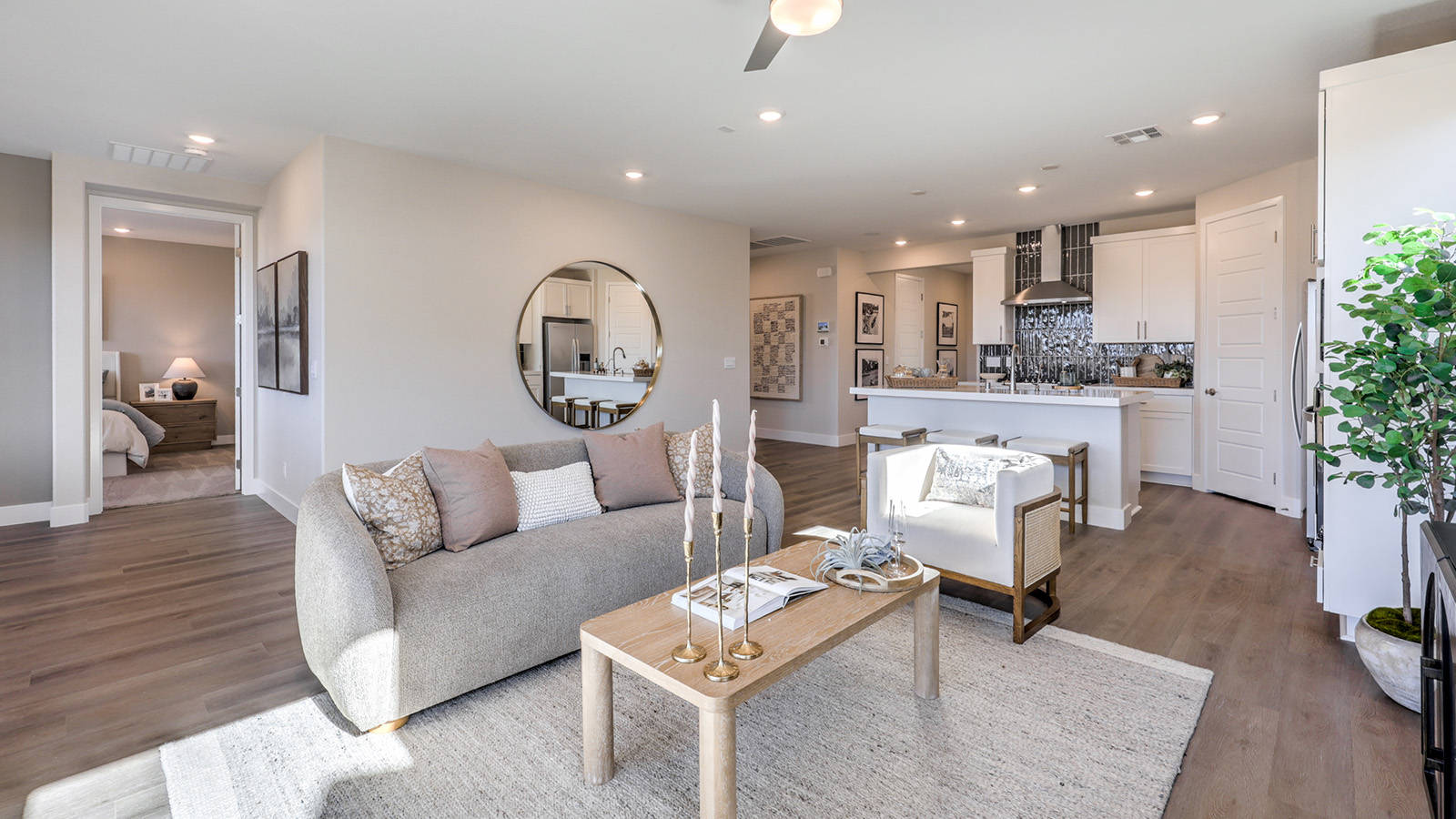 The Majestic Hills 1617 Plan open concept Great Room with LVP panel flooring and windows.