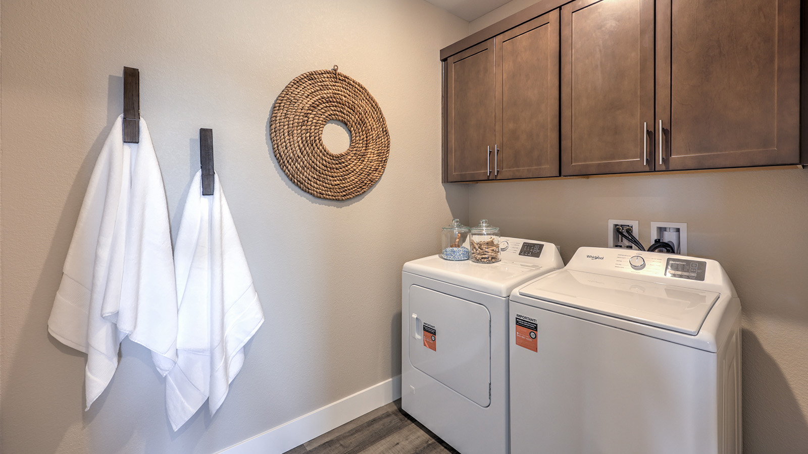 Our Majestic Hills 1870 model laundry room with a shelf and washer and dryer.