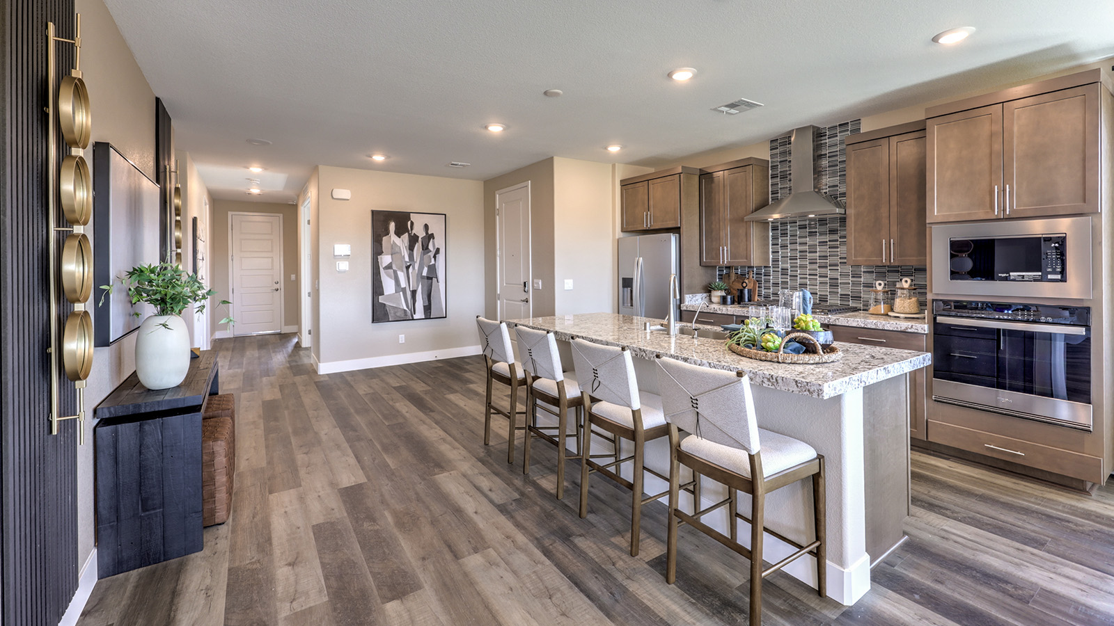 Our 1870 model kitchen in the Majestic Hills Community with white shaker style cabinets, quartz countertops, a kitchen island, large pantry, and Whirlpool Stainless Steel appliances.