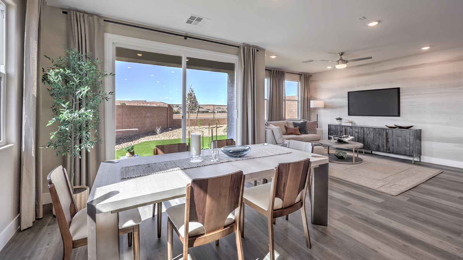 The Majestic Hills 1870 model Dining Room adjacent to the kitchen with a table and two windows.