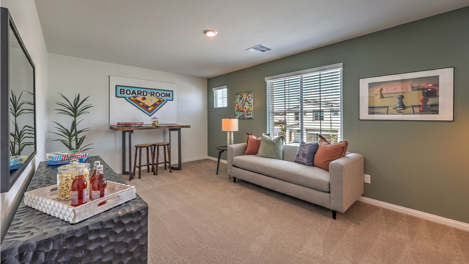 The upstairs loft in our 2600 model with carpet flooring and large windows.