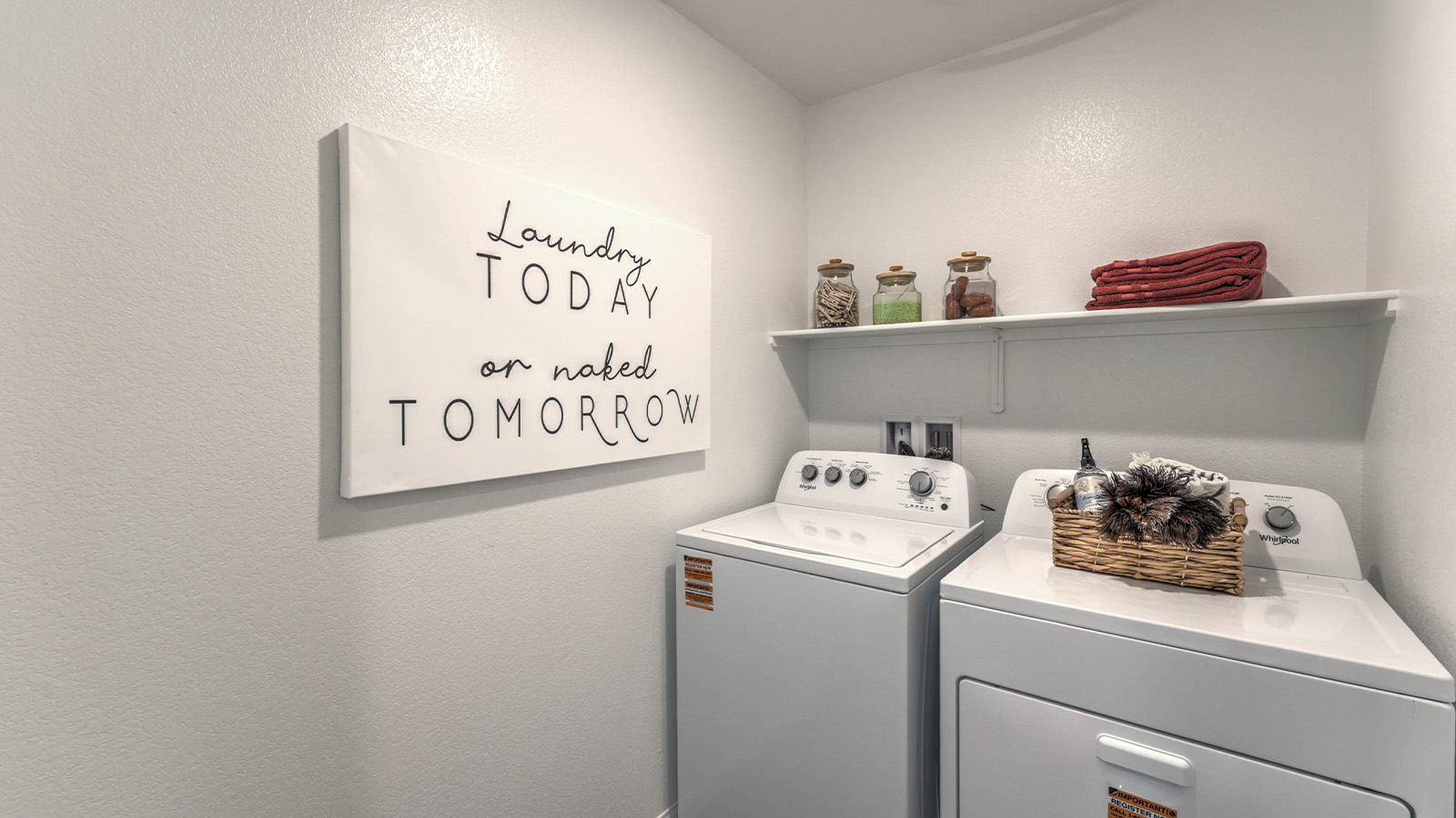 Our Sky Falls 2660 model laundry room with shelves and a washer and dryer.