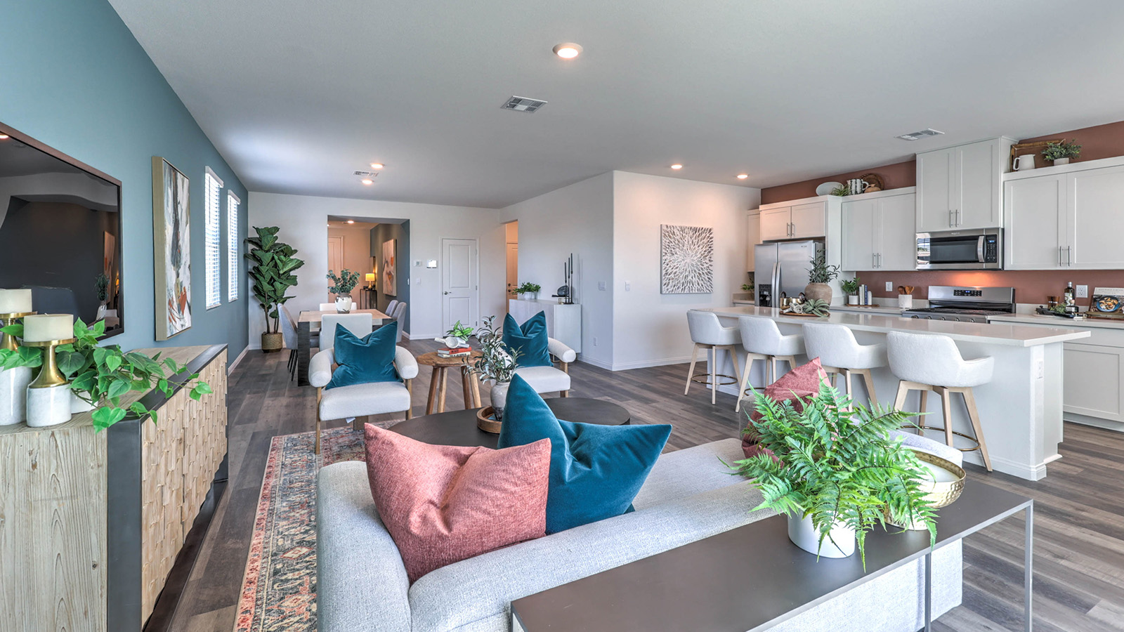 The Sky Falls 3000 Plan open concept Great Room with Luxury Vinyl Plank Flooring, large windows, and a sliding door to the backyard.
