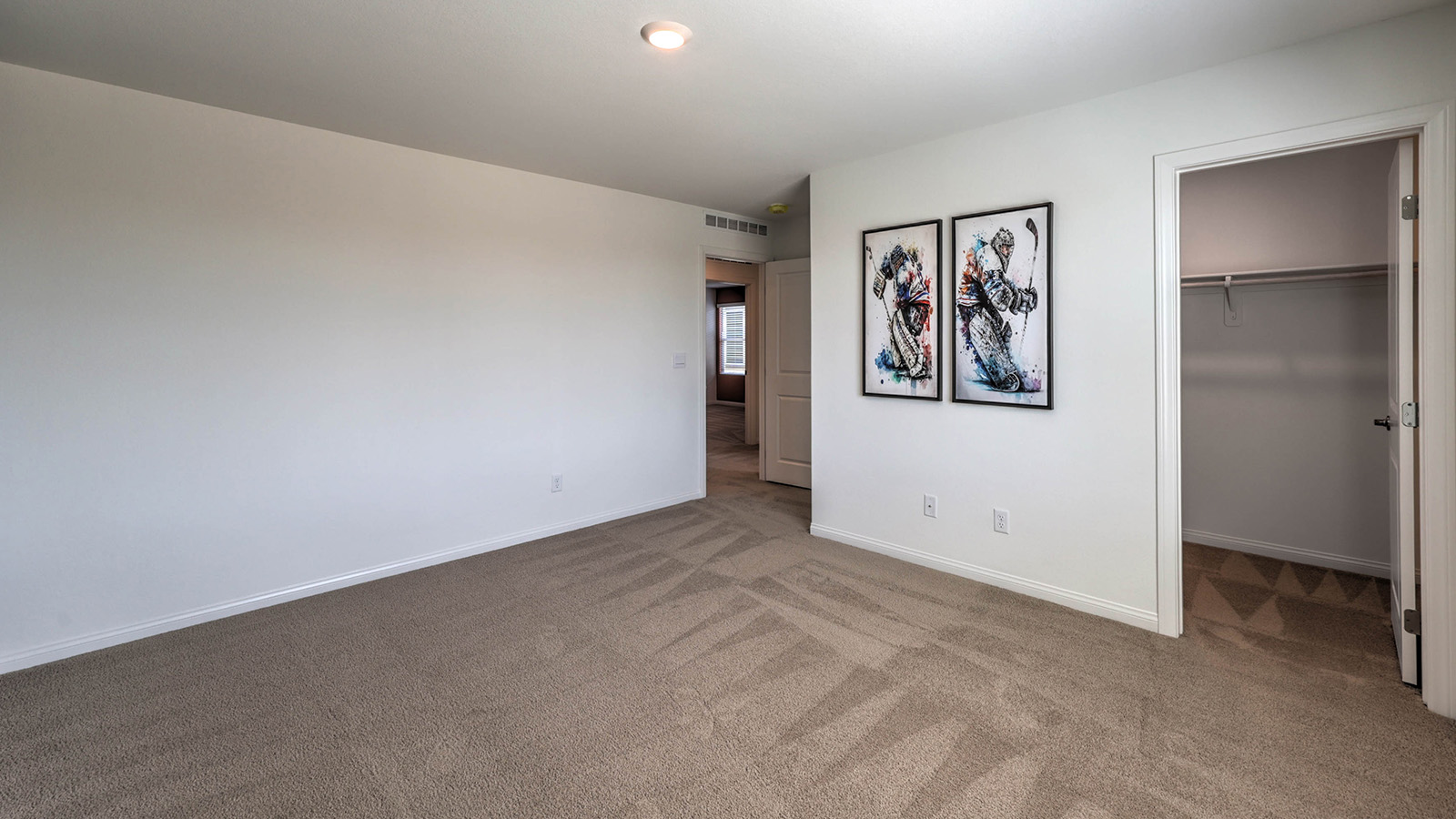 Bedroom Three in our Sky Falls 3000 model with carpet flooring, a sliding closet, and a window.