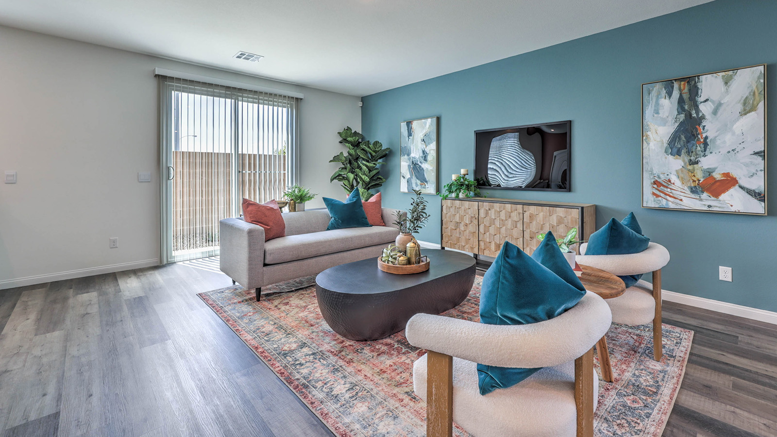 The Sky Falls 3000 Plan open concept Great Room with Luxury Vinyl Plank Flooring, large windows, and a sliding door to the backyard.