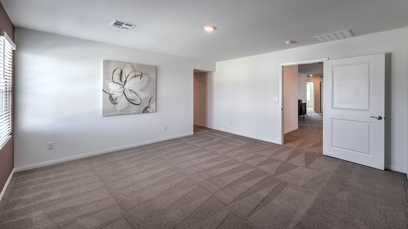 The Bedroom One Suite in our Sky Falls 3000 model with carpet flooring, ceiling fan with a light kit, and large windows.