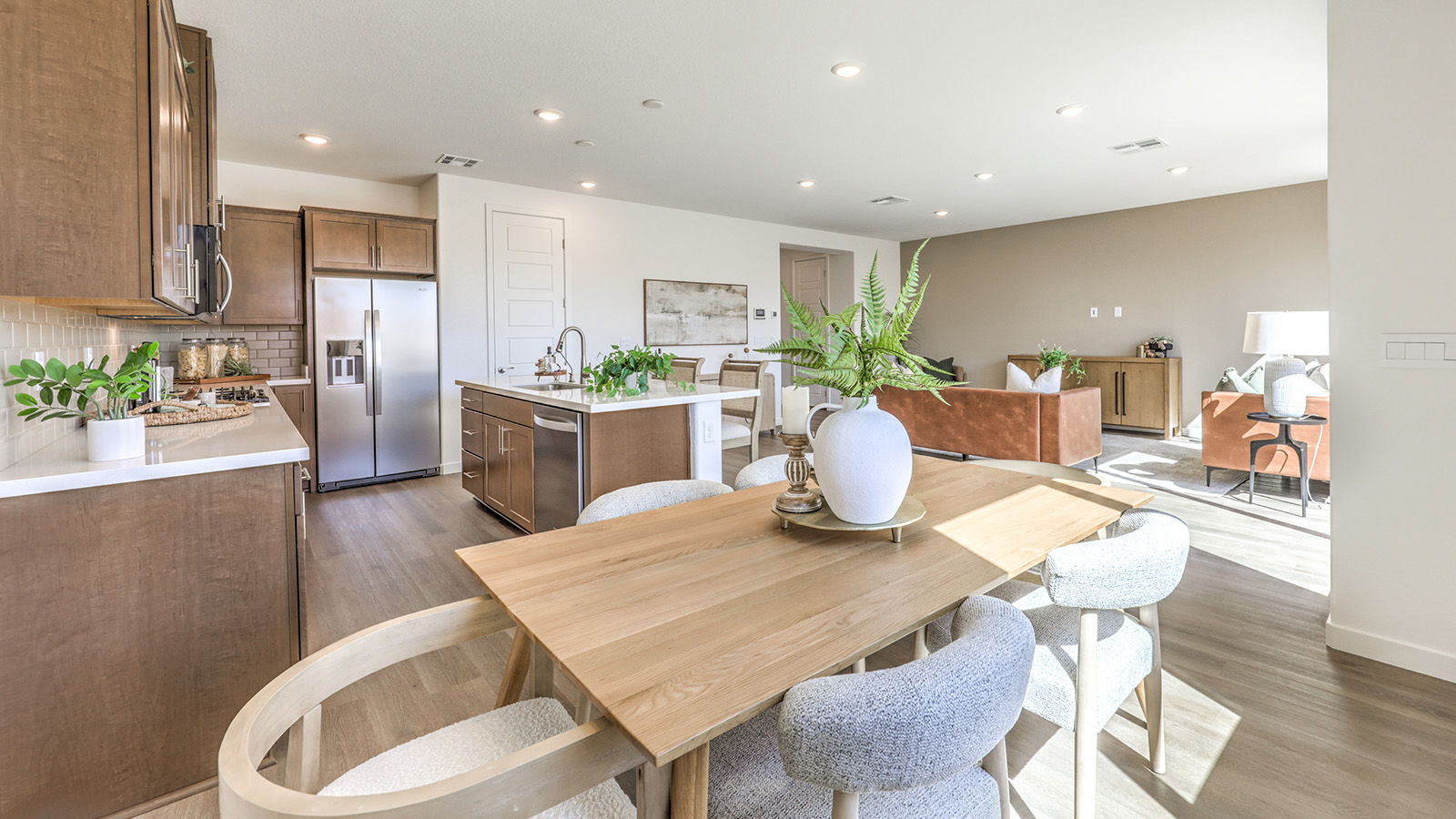 The Arabella Falls 2660 model Dining Room adjacent to the kitchen with a table and window.