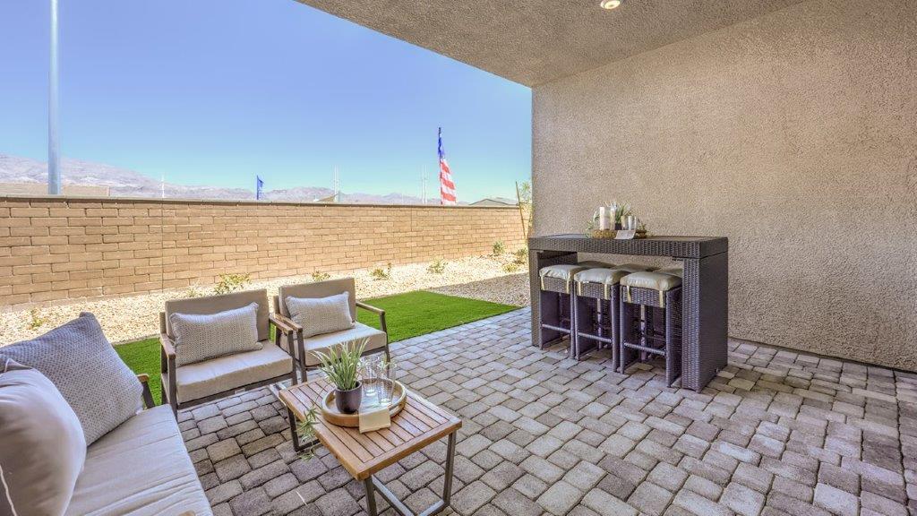 Our Heartland Manor 2538 model backyard with desert landscaping and a covered patio.