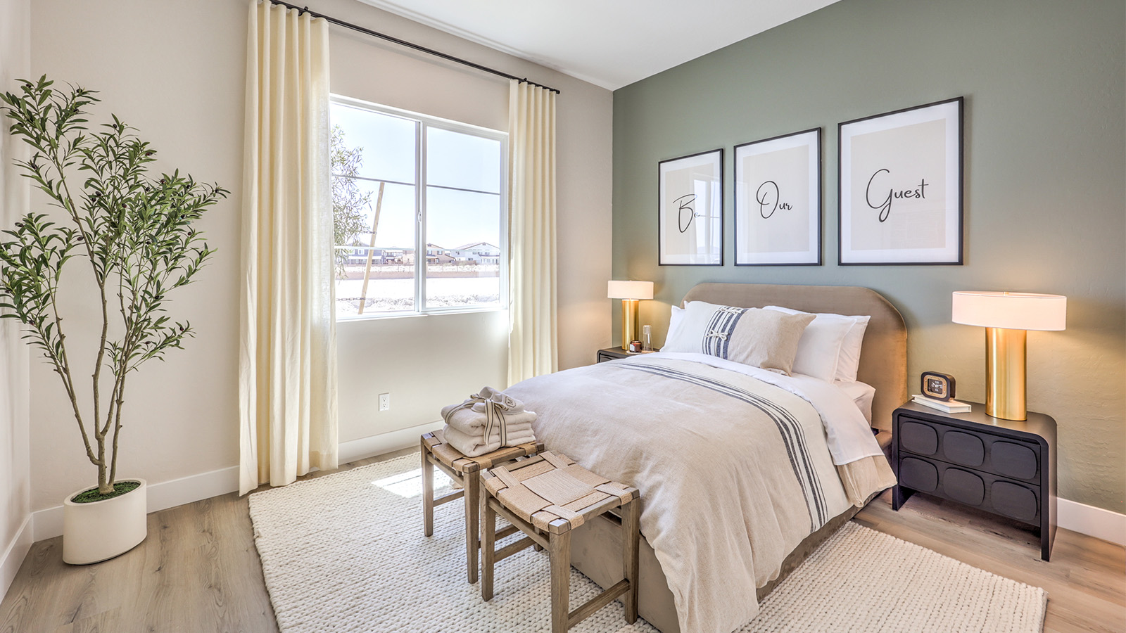 The second bedroom in our Heartland Manor 2754 Plan features plush carpet flooring, a spacious layout, and a large window that fills the room with natural light. The room offers a comfortable and inviting space, perfect for guests or family members.
