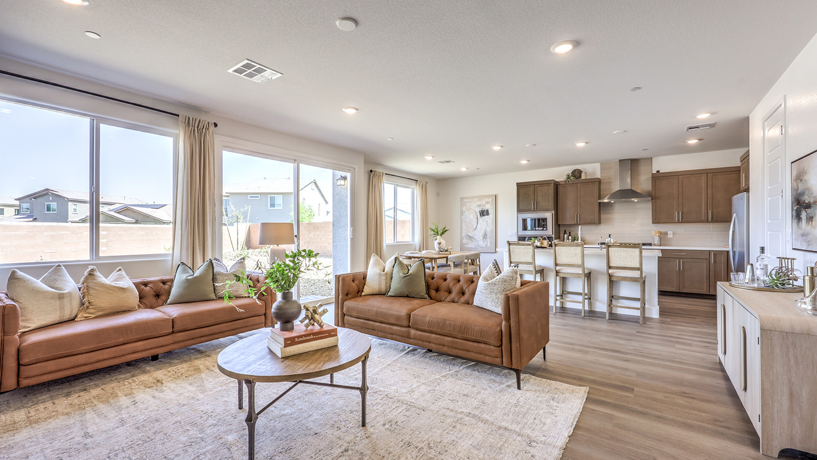 The Serenity 2660 Plan open concept Great Room with ceramic tile flooring, large windows, and a sliding door to the backyard.