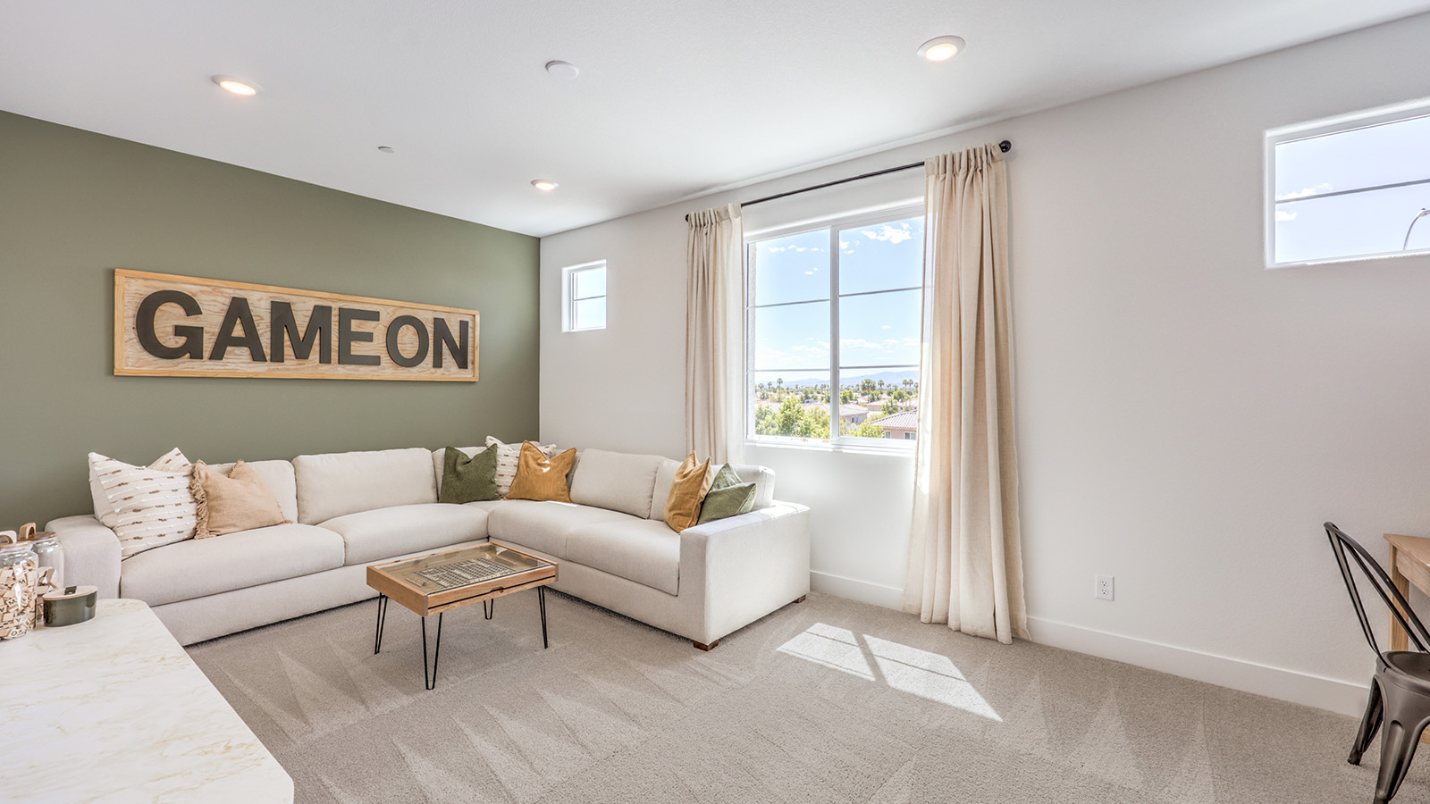 The Loft in our Serenity 2660 plan with carpet flooring and windows.