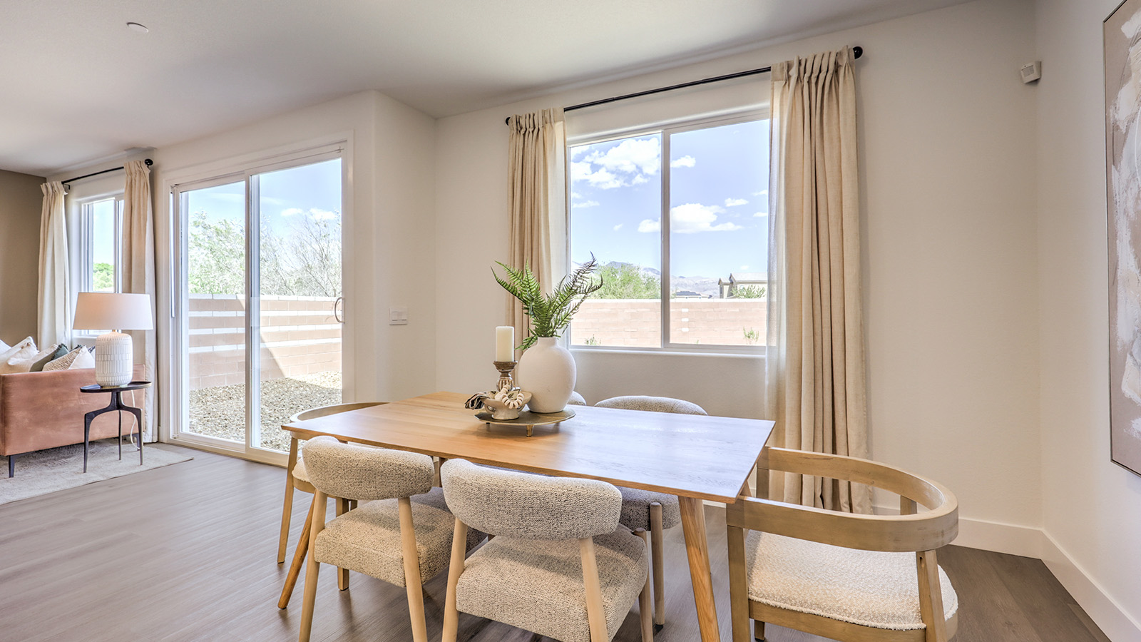 The Serenity 2660 model Dining Room adjacent to the kitchen with a table and window.