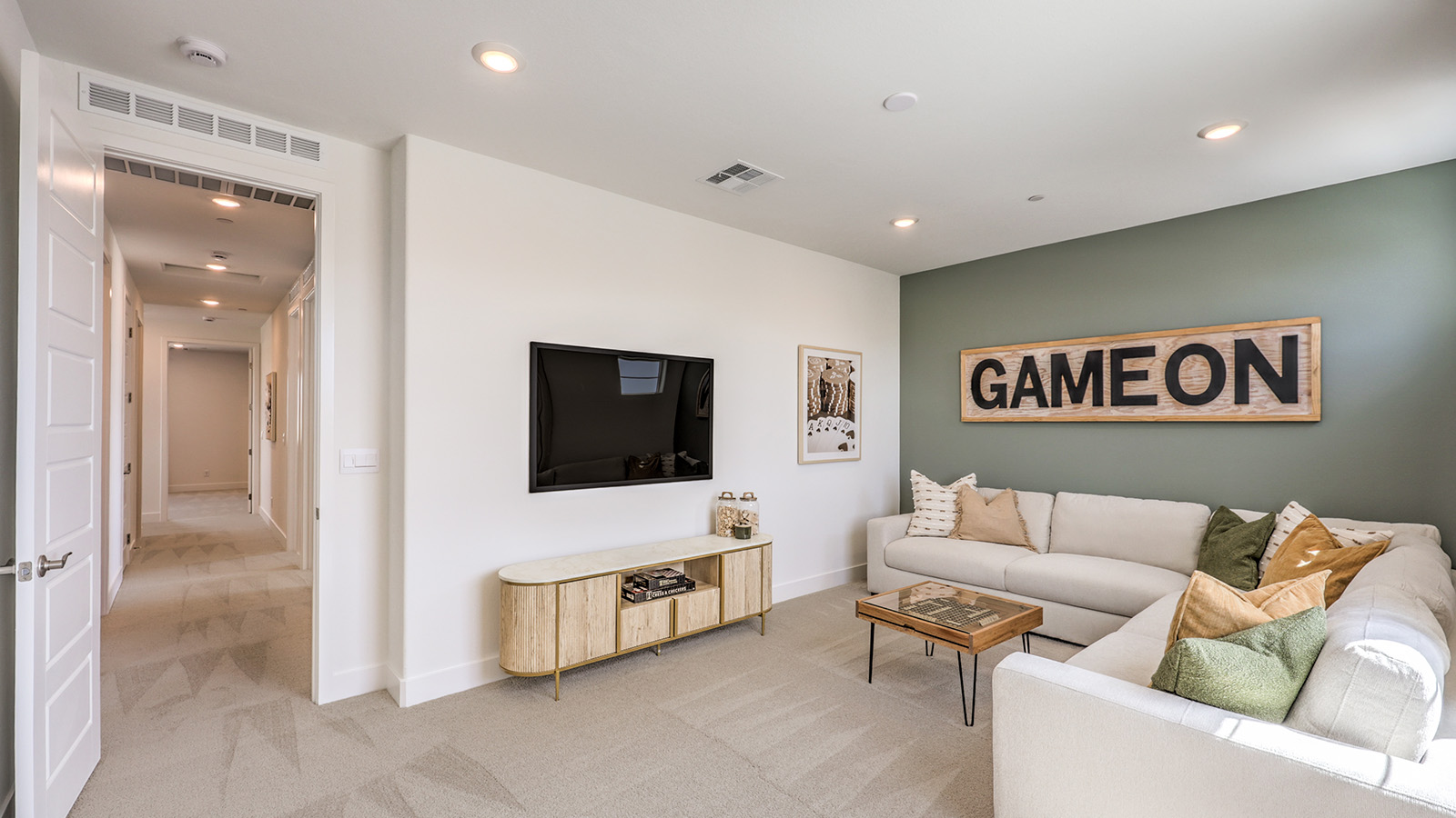 The Loft in our Serenity 2660 plan with carpet flooring and windows.